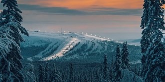 Idre Fjäll på kvällen från långt håll.  Skog i förgrunden.